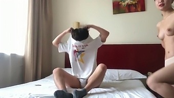 A Pair From China Indulging In Intimacy Within A Hotel Suite